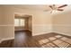 Open living room with hardwood floors and ceiling fan at 2668 Woodfen Dr, Ellenwood, GA 30294
