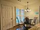 Cozy breakfast nook with glass table and wood chairs near kitchen at 3380 Rock Creek Dr, Rex, GA 30273