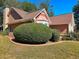 Tan and brick house with a well-maintained lawn at 3380 Rock Creek Dr, Rex, GA 30273