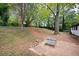 Large backyard with mature trees and patio area at 1847 Elmwood Dr, Austell, GA 30106