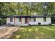 House exterior showcasing a white brick facade and landscaping at 1847 Elmwood Dr, Austell, GA 30106