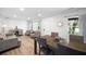 Bright living room with hardwood floors, gray sofas, and a dining area at 1847 Elmwood Dr, Austell, GA 30106