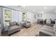 Living room with hardwood floors and gray sofas at 1847 Elmwood Dr, Austell, GA 30106