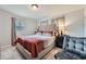 Spacious primary bedroom with a king-size bed and an accent chair at 4809 Hemlock Sw Dr, Austell, GA 30106