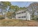 White brick home with mature trees and landscaping at 4809 Hemlock Sw Dr, Austell, GA 30106