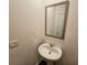 Simple, updated half bathroom with pedestal sink and mirror at 449 Broder Farms Dr, Stockbridge, GA 30281