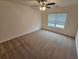Spacious carpeted bedroom with window and ceiling fan at 449 Broder Farms Dr, Stockbridge, GA 30281