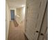 Upstairs hallway with carpeted floor and doors at 449 Broder Farms Dr, Stockbridge, GA 30281