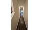Long hallway with dark wood floors leading to living area at 449 Broder Farms Dr, Stockbridge, GA 30281