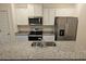 Modern kitchen with granite countertops and stainless steel appliances at 449 Broder Farms Dr, Stockbridge, GA 30281