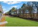 A spacious backyard with a lush green lawn and wooded area at 1002 Rainier Dr, Euharlee, GA 30145