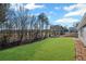 Large backyard with a lush green lawn and wooded area at the edge of the property at 1002 Rainier Dr, Euharlee, GA 30145