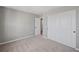 Carpeted bedroom with white sliding closet doors and an open doorway to another room at 1002 Rainier Dr, Euharlee, GA 30145