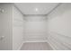 Spacious walk-in closet with white wire shelving maximizing storage capacity and organization at 1002 Rainier Dr, Euharlee, GA 30145