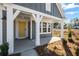 Charming front porch with white columns, yellow door, and manicured landscaping at 1002 Rainier Dr, Euharlee, GA 30145
