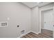 Bright laundry room with wood-look flooring and convenient hookups for washer and dryer at 1002 Rainier Dr, Euharlee, GA 30145