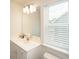 Bathroom with single vanity, toilet and window at 301 Rexmere Rd, Mcdonough, GA 30252