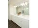 Double vanity bathroom with white cabinets and a large mirror at 301 Rexmere Rd, Mcdonough, GA 30252