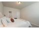 Bright bedroom with ensuite bathroom and white bedding at 301 Rexmere Rd, Mcdonough, GA 30252