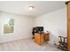 Bright home office features a wooden desk and comfortable rocker at 301 Rexmere Rd, Mcdonough, GA 30252