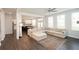 Spacious living room with L-shaped sectional and hardwood floors at 301 Rexmere Rd, Mcdonough, GA 30252