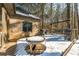 Wooden deck with snow cover, a table, and grill at 570 Pleasant Grove Rd, Mcdonough, GA 30252