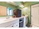 Bathroom with double sinks and a wicker cabinet at 570 Pleasant Grove Rd, Mcdonough, GA 30252