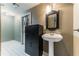 Basement bathroom with pedestal sink, shower, and storage at 570 Pleasant Grove Rd, Mcdonough, GA 30252