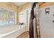 Bathroom with garden tub, shower, and window at 570 Pleasant Grove Rd, Mcdonough, GA 30252