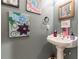 Powder room with pedestal sink and framed art at 570 Pleasant Grove Rd, Mcdonough, GA 30252