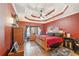Large bedroom with red walls and a king-size bed at 570 Pleasant Grove Rd, Mcdonough, GA 30252