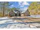 Two-story brick house with a spacious driveway and snow on the ground at 570 Pleasant Grove Rd, Mcdonough, GA 30252