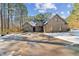 Brick home with a large driveway, partially covered in snow at 570 Pleasant Grove Rd, Mcdonough, GA 30252