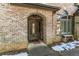 Inviting front entrance with an arched entryway and wooden door at 570 Pleasant Grove Rd, Mcdonough, GA 30252