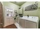 Well-equipped laundry room with washer, dryer, and storage cabinets at 570 Pleasant Grove Rd, Mcdonough, GA 30252