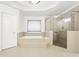 Elegant bathroom with soaking tub and walk-in shower at 206 Woodridge Pkwy, Canton, GA 30115