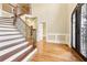 Elegant entryway with hardwood floors and grand staircase at 206 Woodridge Pkwy, Canton, GA 30115