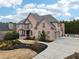 Brick house with 3 car garage, pool, and manicured landscaping at 206 Woodridge Pkwy, Canton, GA 30115