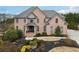 Two-story brick home with landscaped yard and large driveway at 206 Woodridge Pkwy, Canton, GA 30115