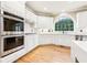 Modern kitchen with white cabinets, stainless steel appliances, and an island at 206 Woodridge Pkwy, Canton, GA 30115