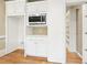 Kitchen features white cabinets, microwave, and pantry at 206 Woodridge Pkwy, Canton, GA 30115