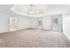 View of the large main bedroom with carpeted floors and tray ceiling with fan at 206 Woodridge Pkwy, Canton, GA 30115