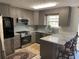 Modern kitchen with granite countertops and stainless steel appliances at 517 Carrington Ct, Canton, GA 30115