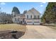 Charming two-story home showcasing a well-maintained lawn, two-car garage, and traditional architectural details at 2230 Mcbrayer Ct, Cumming, GA 30028