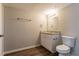 Clean bathroom with granite countertop, white vanity, and vinyl flooring at 3485 Tarragon Dr, Decatur, GA 30034