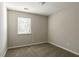 Bright bedroom featuring a window with blinds and carpet flooring at 3485 Tarragon Dr, Decatur, GA 30034
