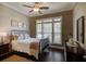 Cozy bedroom with a metal bed frame and large window at 314 Lakeside Trce, Canton, GA 30115