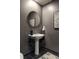 Small bathroom with a pedestal sink and dark gray walls at 805 Peachtree Ne St # 212, Atlanta, GA 30308