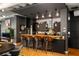 Modern kitchen with dark cabinetry, wood countertops, and breakfast bar at 805 Peachtree Ne St # 212, Atlanta, GA 30308