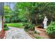 Landscaped backyard with flagstone path, fountain, and lush greenery at 1120 Heards Ferry Rd, Sandy Springs, GA 30328